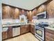Well-lit kitchen features stainless steel appliances, granite countertops, wood cabinets, and backsplash detail at 2260 Leyden St, Denver, CO 80207