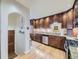 Traditional kitchen with wood cabinets, stone countertops, and stainless steel appliances at 2260 Leyden St, Denver, CO 80207