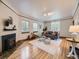 Bright living room featuring hardwood floors, fireplace, and large windows for ample natural light at 2260 Leyden St, Denver, CO 80207