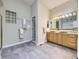 Elegant bathroom with double sinks, wood cabinets, tile flooring, and glass block window at 2260 Leyden St, Denver, CO 80207