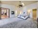 Spacious main bedroom with ceiling fan, ensuite bathroom, and ample natural light from skylight at 2260 Leyden St, Denver, CO 80207