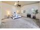 Spacious main bedroom featuring a ceiling fan, skylight, and generous natural light at 2260 Leyden St, Denver, CO 80207