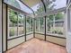 Bright sunroom enclosed with many windows offers backyard views and natural lighting at 2260 Leyden St, Denver, CO 80207