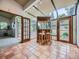 Inviting sunroom features tiled floors, skylights, French doors and a custom bar area at 2260 Leyden St, Denver, CO 80207