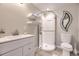Clean bathroom with glass-enclosed shower, floating shelves, and modern vanity at 1312 Pine View Rd, Golden, CO 80403
