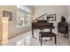 Cozy room with a grand piano, large windows, and natural light, ideal for music or relaxation at 1312 Pine View Rd, Golden, CO 80403