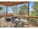 Outdoor deck area with patio table, four chairs, and furniture for relaxing and entertaining at 1312 Pine View Rd, Golden, CO 80403