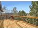 Wooden deck with black metal railing and scenic mountain views at 1312 Pine View Rd, Golden, CO 80403