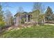Beautiful two-story home with stone accents, manicured lawn, and mature trees at 1312 Pine View Rd, Golden, CO 80403