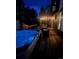 Night view of hot tub and outdoor entertaining area with a covered deck and string lights at 1312 Pine View Rd, Golden, CO 80403