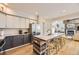 Modern kitchen with a stainless steel refrigerator, kitchen island with seating, and hardwood floors at 1312 Pine View Rd, Golden, CO 80403