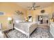 Spacious main bedroom with king bed, ceiling fan, and view into the en suite bathroom at 1312 Pine View Rd, Golden, CO 80403