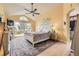 Spacious main bedroom with vaulted ceiling, ceiling fan, and sliding door to the balcony at 1312 Pine View Rd, Golden, CO 80403