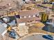 Aerial view of a two-story home with a front porch, attached garage, and a paved driveway at 1456 S Jasper St, Aurora, CO 80017