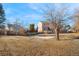 The backyard has a fence, a concrete slab, a deck area, and mature trees at 1456 S Jasper St, Aurora, CO 80017