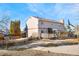 Backyard with wood fence, patio, and enclosed porch on the rear of the home at 1456 S Jasper St, Aurora, CO 80017