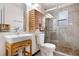 Updated bathroom featuring modern vanity and tiled glass-enclosed shower at 1456 S Jasper St, Aurora, CO 80017