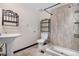 Classic bathroom with pedestal sink and tiled shower area, ready for a refresh at 1456 S Jasper St, Aurora, CO 80017