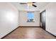 A cozy bedroom with wood-look flooring and a window offering natural light at 1456 S Jasper St, Aurora, CO 80017