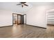 A spacious bedroom featuring a walk-in closet, wood-look floors, and bright natural light at 1456 S Jasper St, Aurora, CO 80017