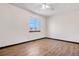 Bright bedroom features wood-look flooring and a window with natural light at 1456 S Jasper St, Aurora, CO 80017