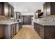 Modern kitchen featuring dark cabinets, stainless steel appliances, and a spacious layout at 1456 S Jasper St, Aurora, CO 80017