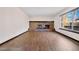 A spacious living room with wood floors and a brick fireplace creates a warm and inviting atmosphere at 1456 S Jasper St, Aurora, CO 80017