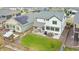 This home features a patio with furniture, a well-maintained lawn, and solar panels on the neighboring house at 17276 E 103Rd Ave, Commerce City, CO 80022