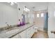 Bright and spacious bathroom featuring double sinks with granite countertops and a shower at 17276 E 103Rd Ave, Commerce City, CO 80022