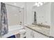 Clean white bathroom features a tub/shower combination and granite countertop vanity at 17276 E 103Rd Ave, Commerce City, CO 80022