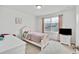 Comfortable bedroom with a twin bed, desk, and a window overlooking the neighborhood at 17276 E 103Rd Ave, Commerce City, CO 80022