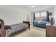 Bright bedroom featuring two twin beds and a large window with neighborhood views at 17276 E 103Rd Ave, Commerce City, CO 80022
