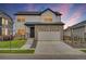 Charming two-story home features a stone facade, white siding, and a spacious two-car garage at 17276 E 103Rd Ave, Commerce City, CO 80022