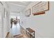 This home features a welcoming hallway with wood floors, coat rack and a view to the dining room at 17276 E 103Rd Ave, Commerce City, CO 80022