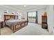Spacious main bedroom with tray ceiling, three windows and a king-sized bed at 17276 E 103Rd Ave, Commerce City, CO 80022