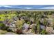 Panoramic aerial view of the community showcasing lush green trees and the Denver skyline on the horizon at 7126 Cedarwood Cir, Boulder, CO 80301