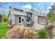 Backyard patio with outdoor dining set, rock landscaping and manicured lawn, perfect for outdoor entertaining at 7126 Cedarwood Cir, Boulder, CO 80301