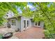 Backyard with a brick patio, trimmed landscaping, and string lights hung above a dining space with views of the home at 7126 Cedarwood Cir, Boulder, CO 80301