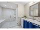 Modern bathroom with a glass-enclosed shower, tile flooring, and a stylish vanity with a sink at 7126 Cedarwood Cir, Boulder, CO 80301