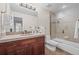 Bathroom with single sink vanity, dark wood cabinets, and shower with glass door at 7126 Cedarwood Cir, Boulder, CO 80301