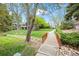 Scenic community featuring a walking bridge and lush greenery with neighborhood homes in the background at 7126 Cedarwood Cir, Boulder, CO 80301