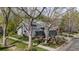 Charming gray home with mature trees, green lawn, a small patio, and well-maintained landscaping at 7126 Cedarwood Cir, Boulder, CO 80301
