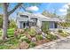 Attractive home showcasing a stone waterfall feature, landscaped yard, and an attached two-car garage at 7126 Cedarwood Cir, Boulder, CO 80301