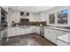 Modern kitchen featuring stainless steel appliances, custom cabinets, granite countertops, and stone floors at 7126 Cedarwood Cir, Boulder, CO 80301