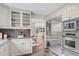 Bright kitchen featuring stainless steel appliances, custom cabinets, and granite countertops at 7126 Cedarwood Cir, Boulder, CO 80301