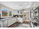 Bright kitchen boasting stainless steel appliances, granite countertops, and sleek gray cabinetry at 7126 Cedarwood Cir, Boulder, CO 80301