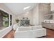 Spacious living room with a fireplace, skylight, and hardwood floors, creating an inviting atmosphere at 7126 Cedarwood Cir, Boulder, CO 80301