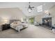 Bright main bedroom boasts vaulted ceiling, fireplace, ceiling fan, skylights, and private patio access at 7126 Cedarwood Cir, Boulder, CO 80301