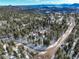 Aerial view of home nestled in snowy mountain community at 11498 Pauls Ln, Conifer, CO 80433