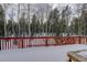 Back deck with wooden railing overlooking a snowy landscape at 11498 Pauls Ln, Conifer, CO 80433